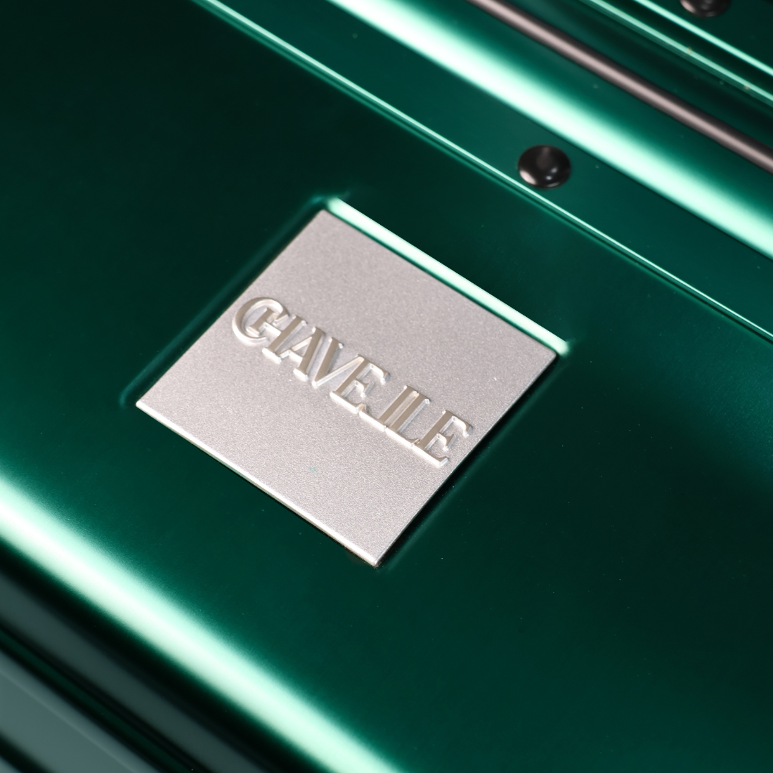 CHAVELLE luxury aluminium suitcase stone green close-up of top handle and metal logo