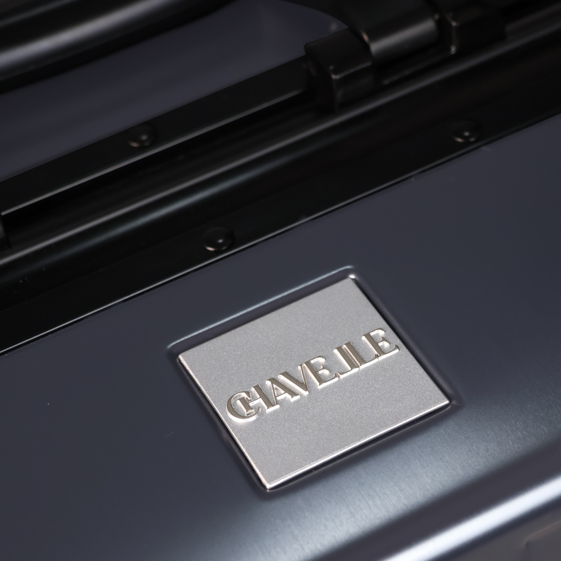 CHAVELLE luxury aluminium suitcase gun metal close-up of top handle and metal logo