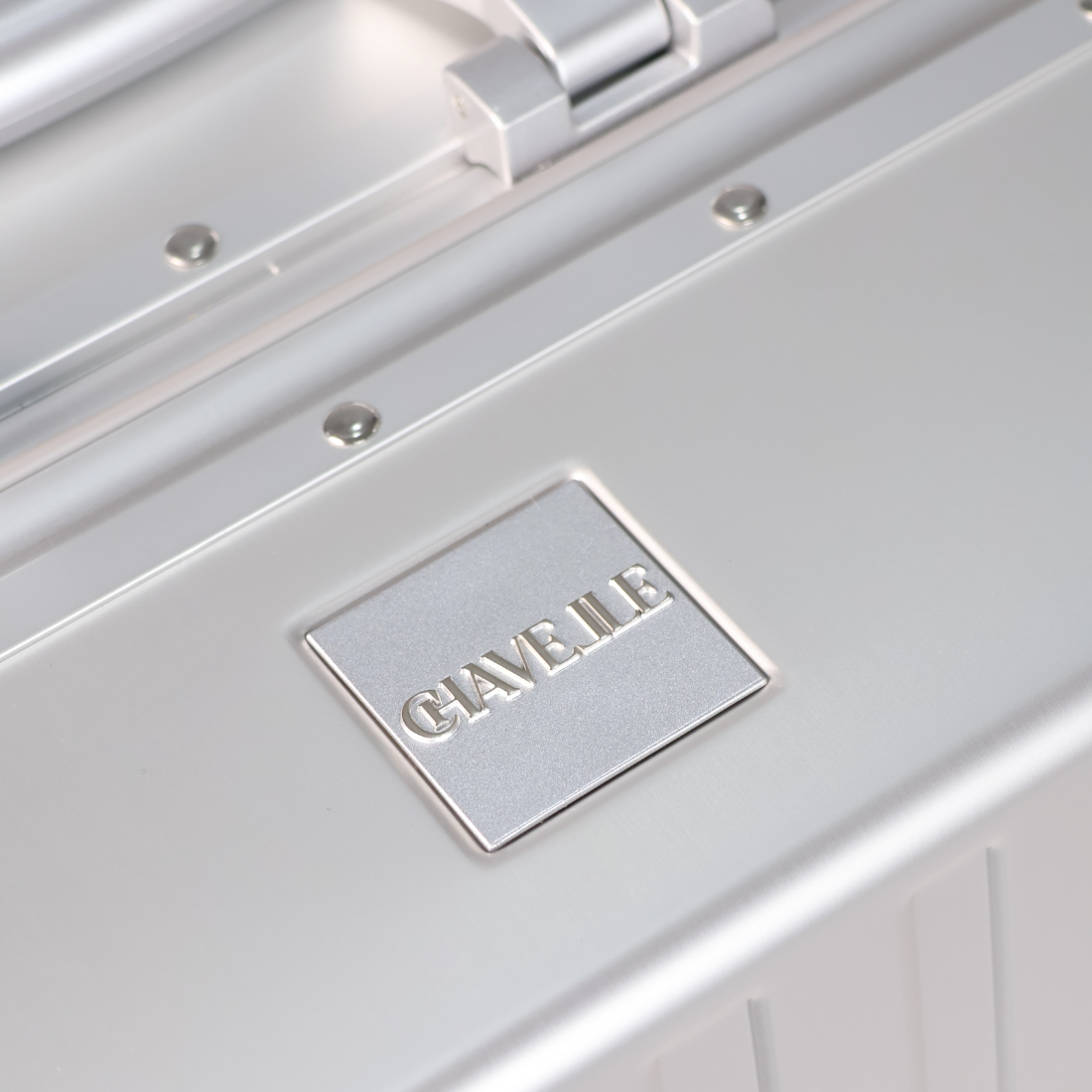 CHAVELLE luxury aluminium suitcase silver close-up of top handle and metal logo