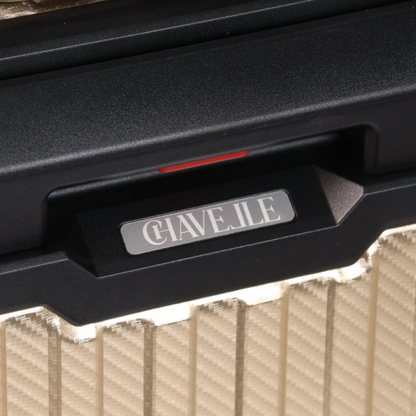 Close-up of a black suitcase handle with 'CHAVELLE' branding on a textured surface.