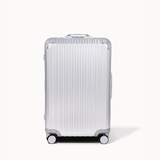 Silver suitcase with a ribbed texture on a white background
