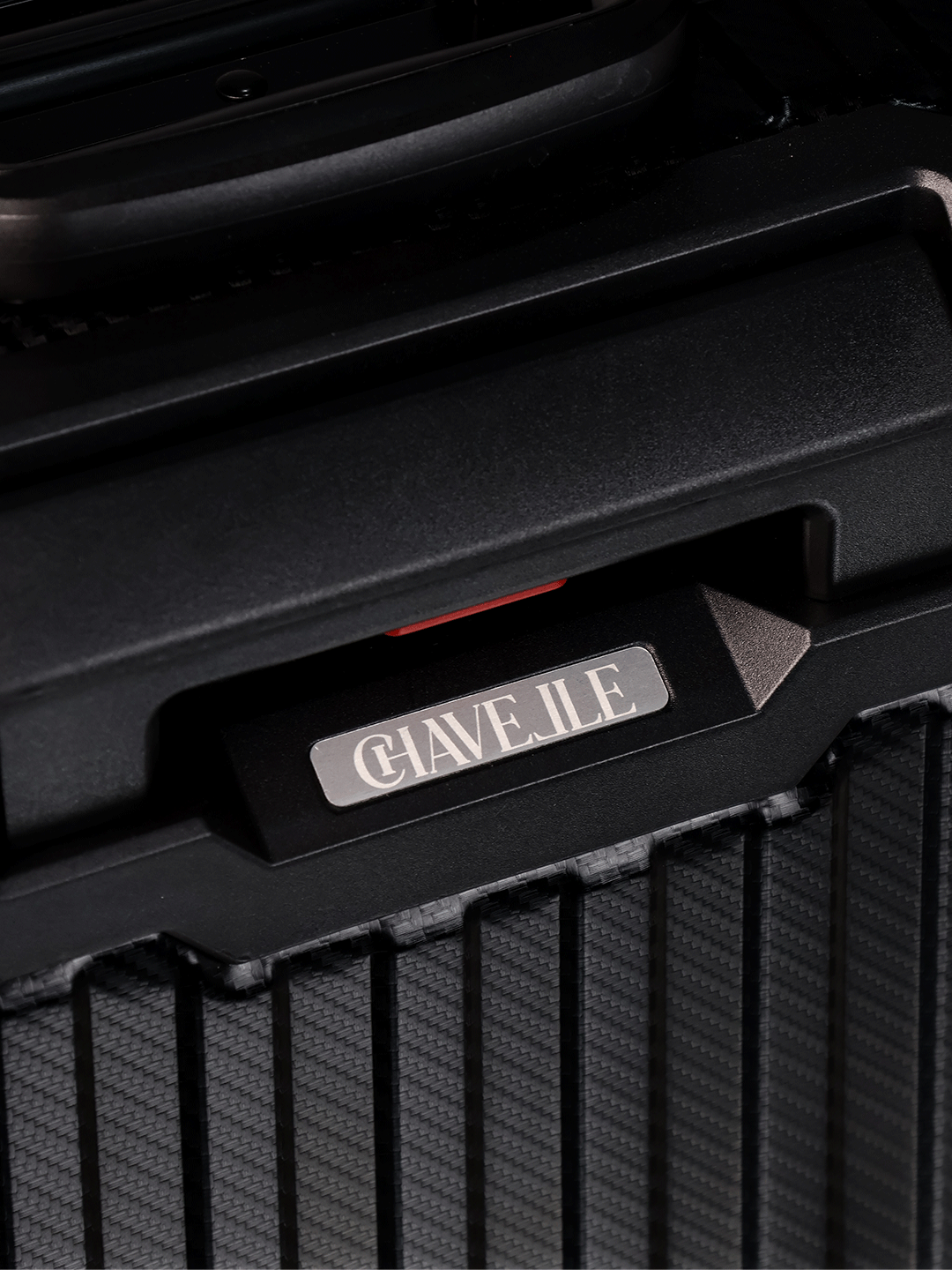 Close-up of a black suitcase with 'CHAVELLE' branding on a dark background