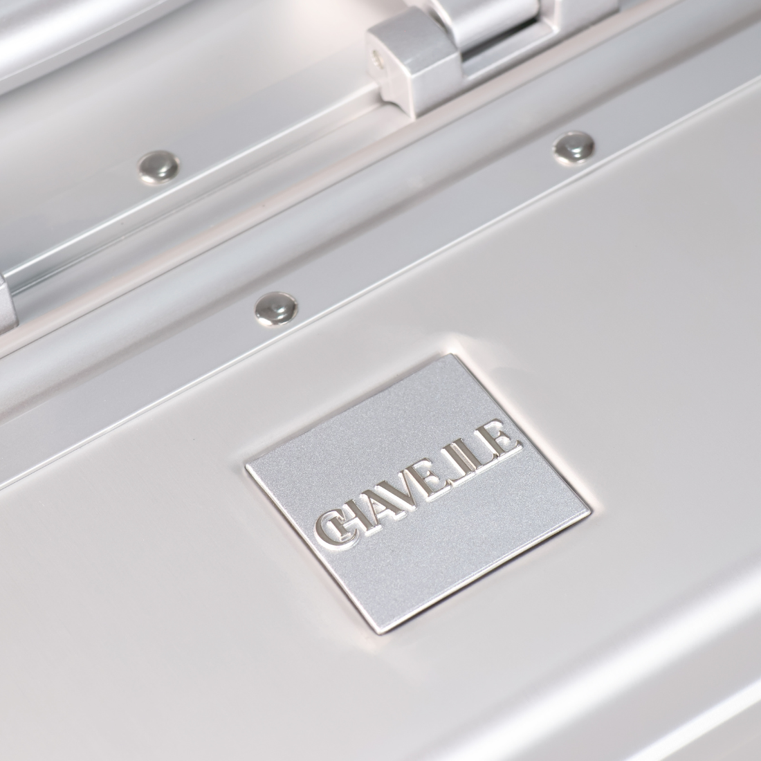CHAVELLE luxury aluminium suitcase silver close-up of top handle and metal logo