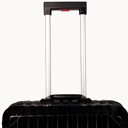 Black suitcase with a visible handle on a white background