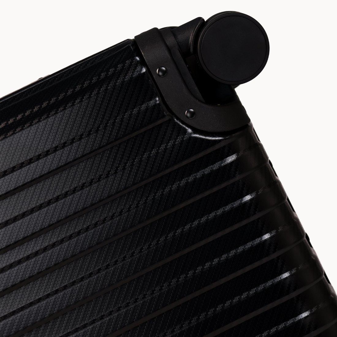 Close-up of a black suitcase handle on a white background