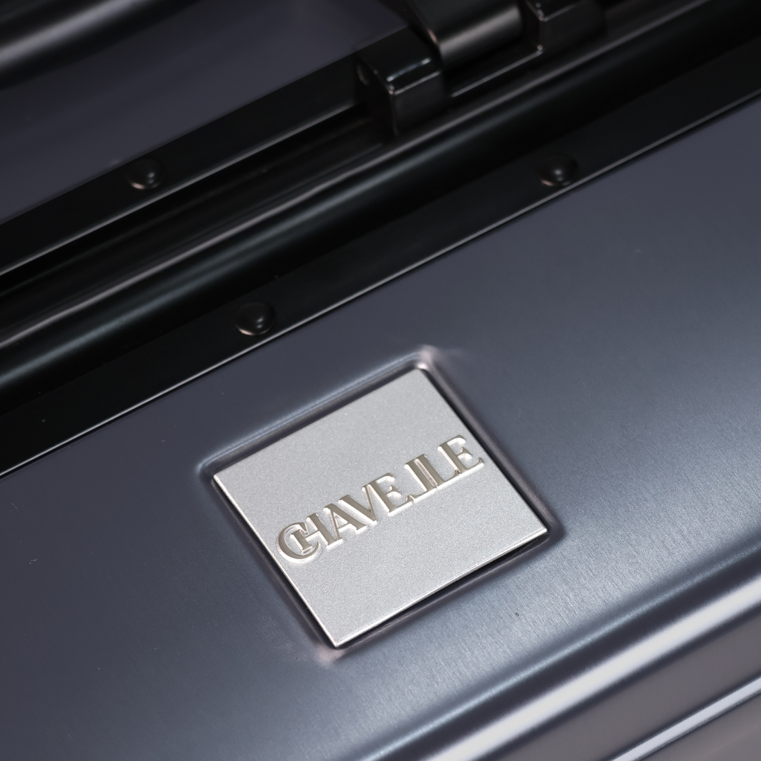 CHAVELLE luxury aluminium suitcase  gun metal close-up of top handle and metal logo