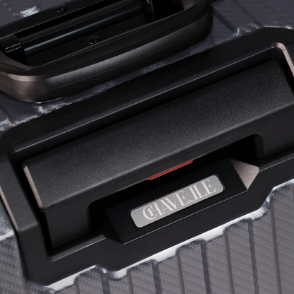 Close-up of a black suitcase handle with 'CHAVELLE' branding on a textured surface.