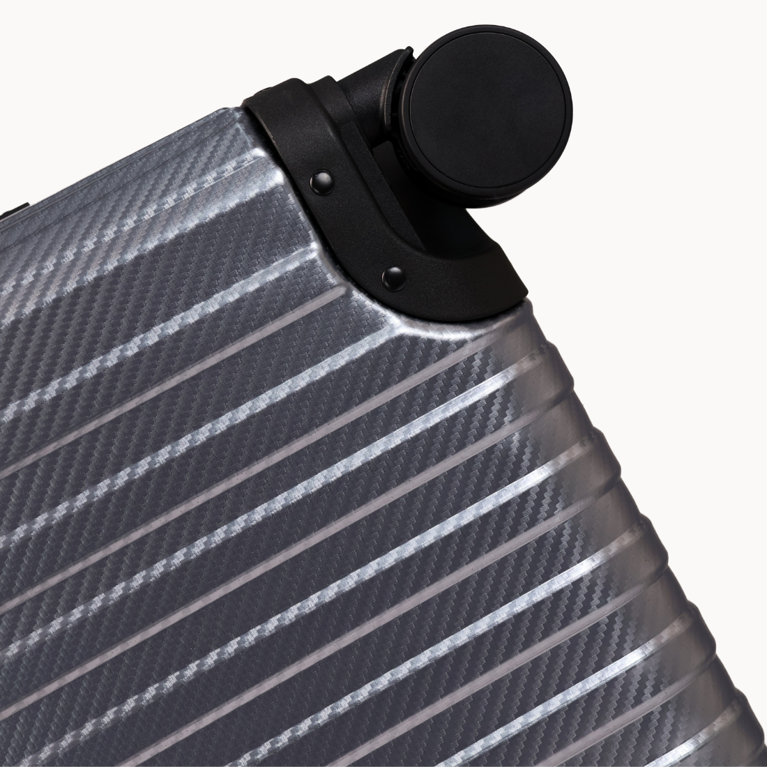 Close-up of a silver suitcase with black handle on a white background