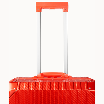 Red suitcase with a textured surface on a white background