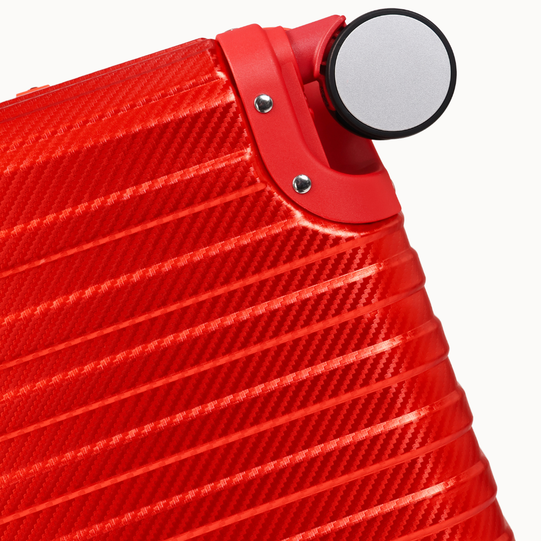 Close-up of a red suitcase with a silver handle on a white background