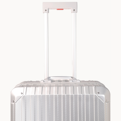 Silver suitcase with a white handle on a white background