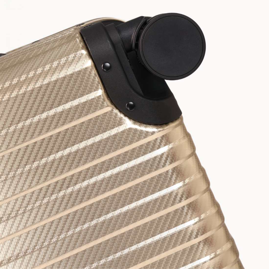 Close-up of a beige suitcase with a black handle on a white background