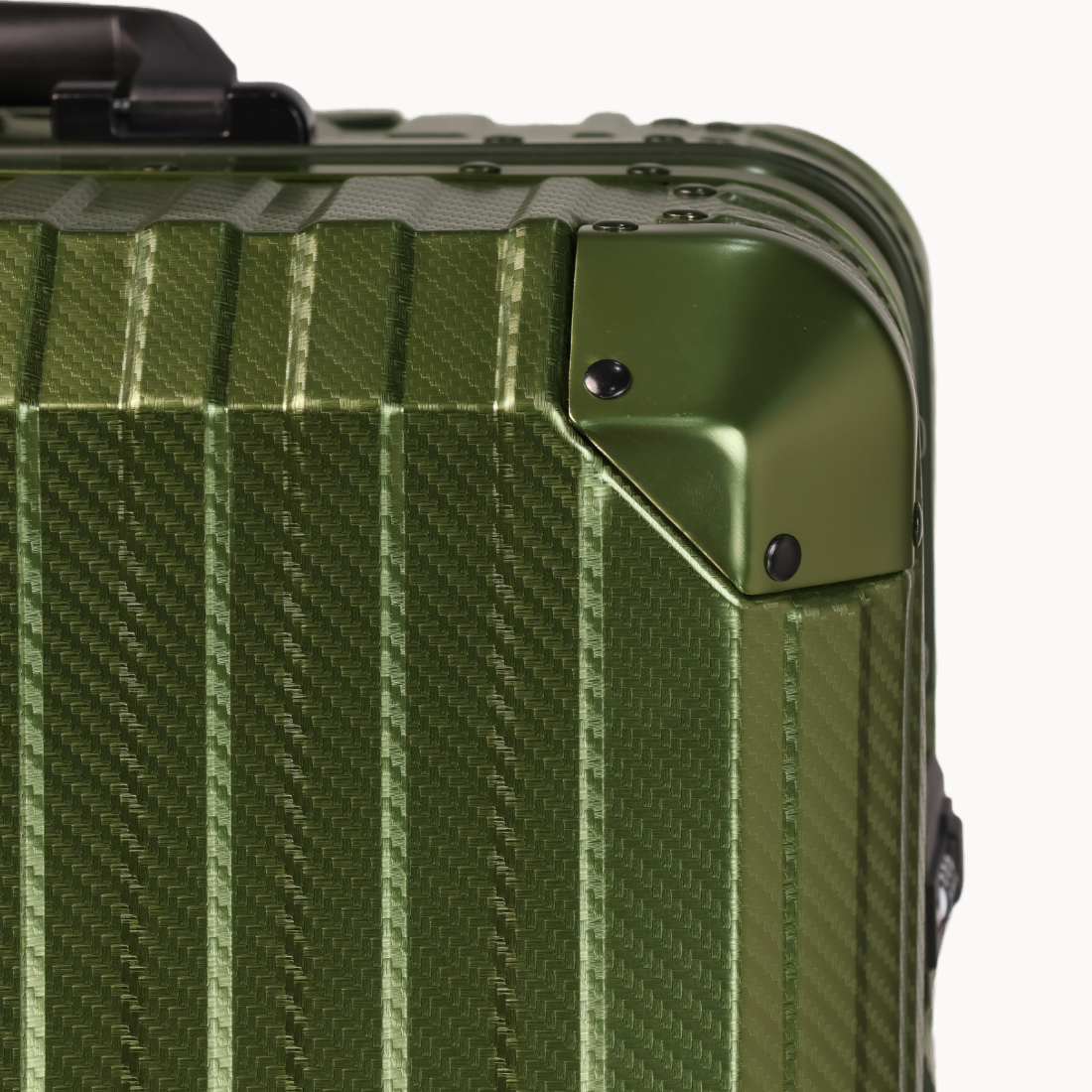 Close-up of a green suitcase with a textured surface