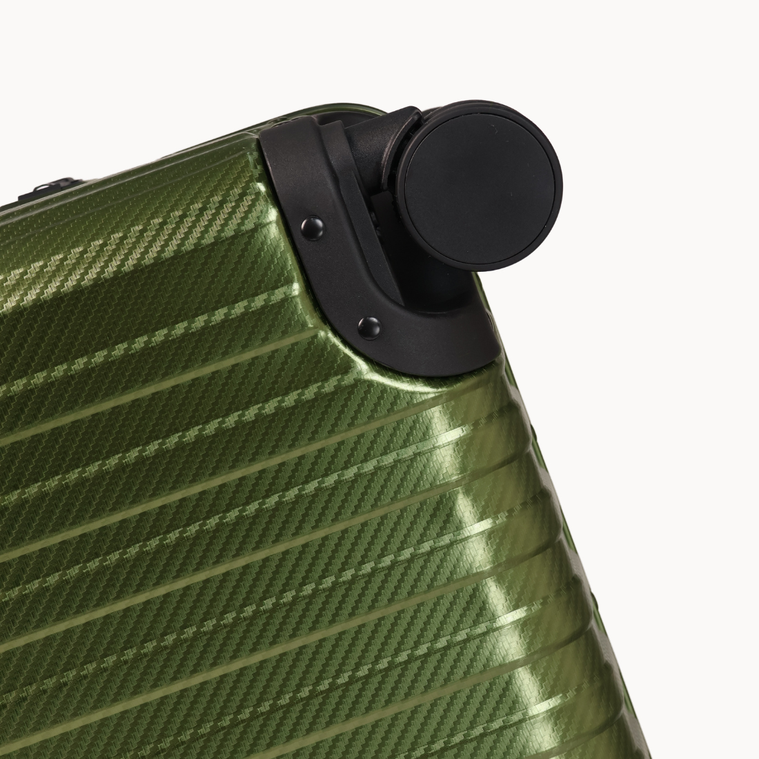 Close-up of a green suitcase with a black handle on a white background