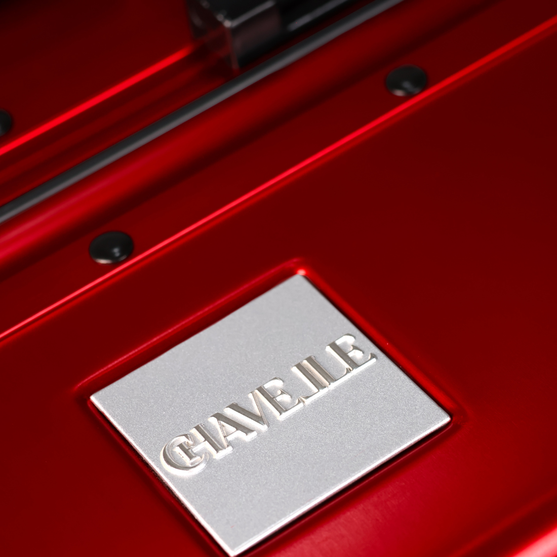 CHAVELLE luxury aluminium suitcase cherry red close-up of top handle and metal logo