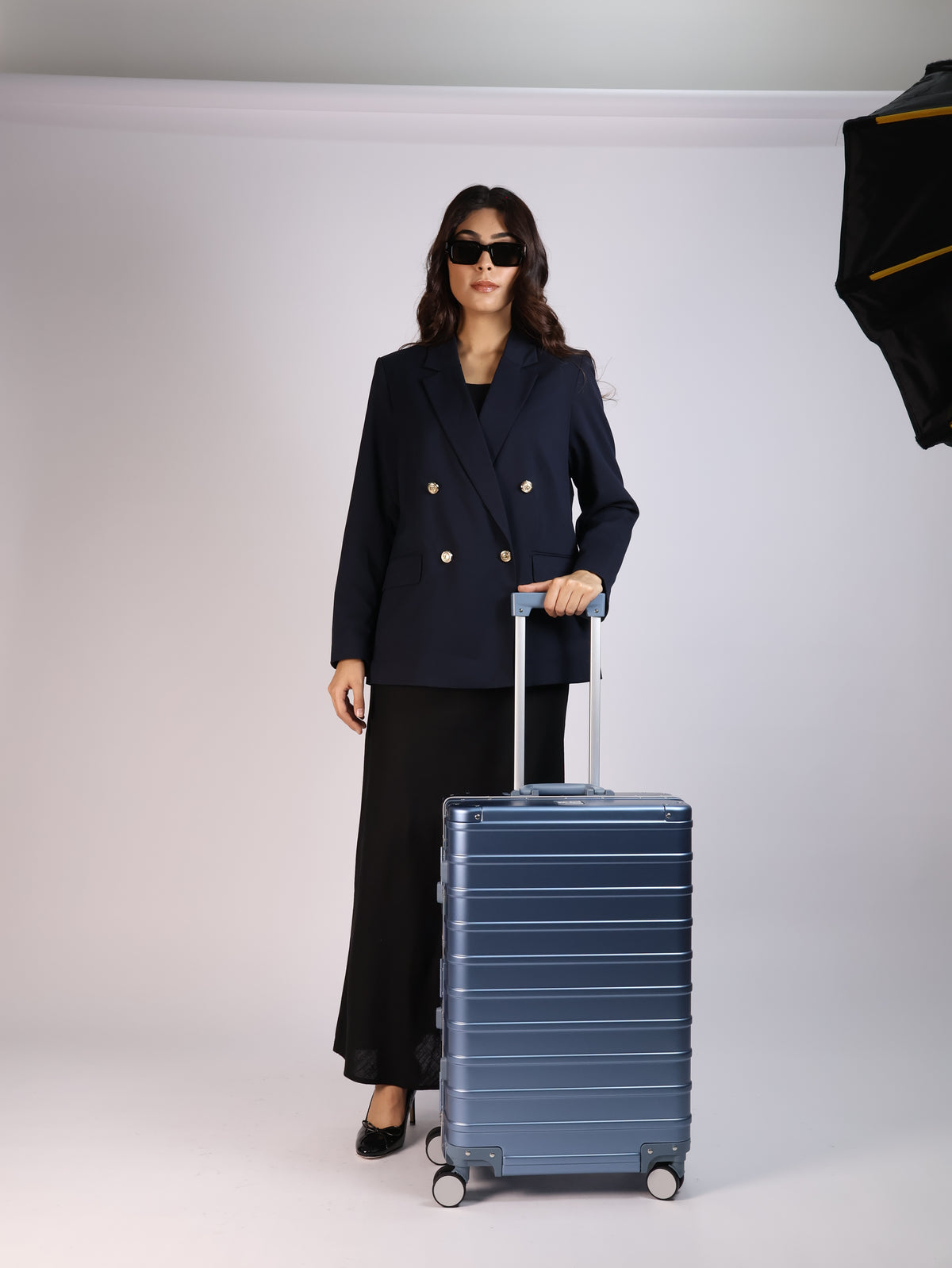 Elegant model showcasing CHAVELLE Classic Series suitcase in blue finish