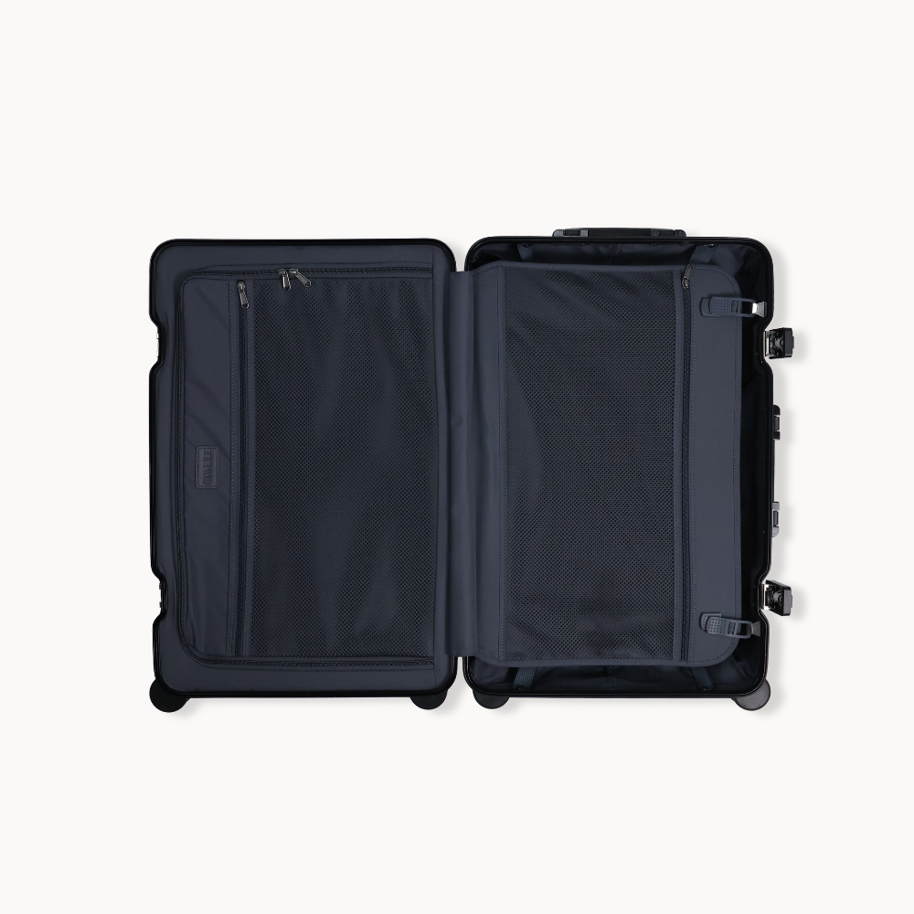 Black suitcase with open compartments on a white background