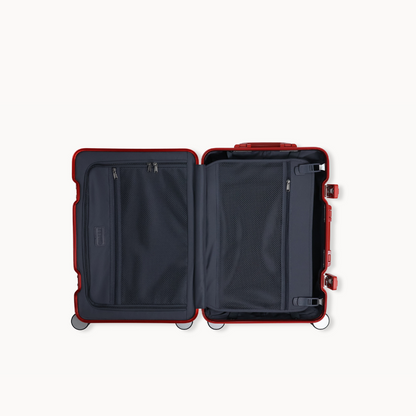 Open suitcase with red frame and black interior on a white background