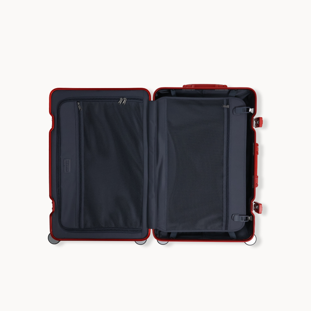 Open red suitcase with black interior on a white background