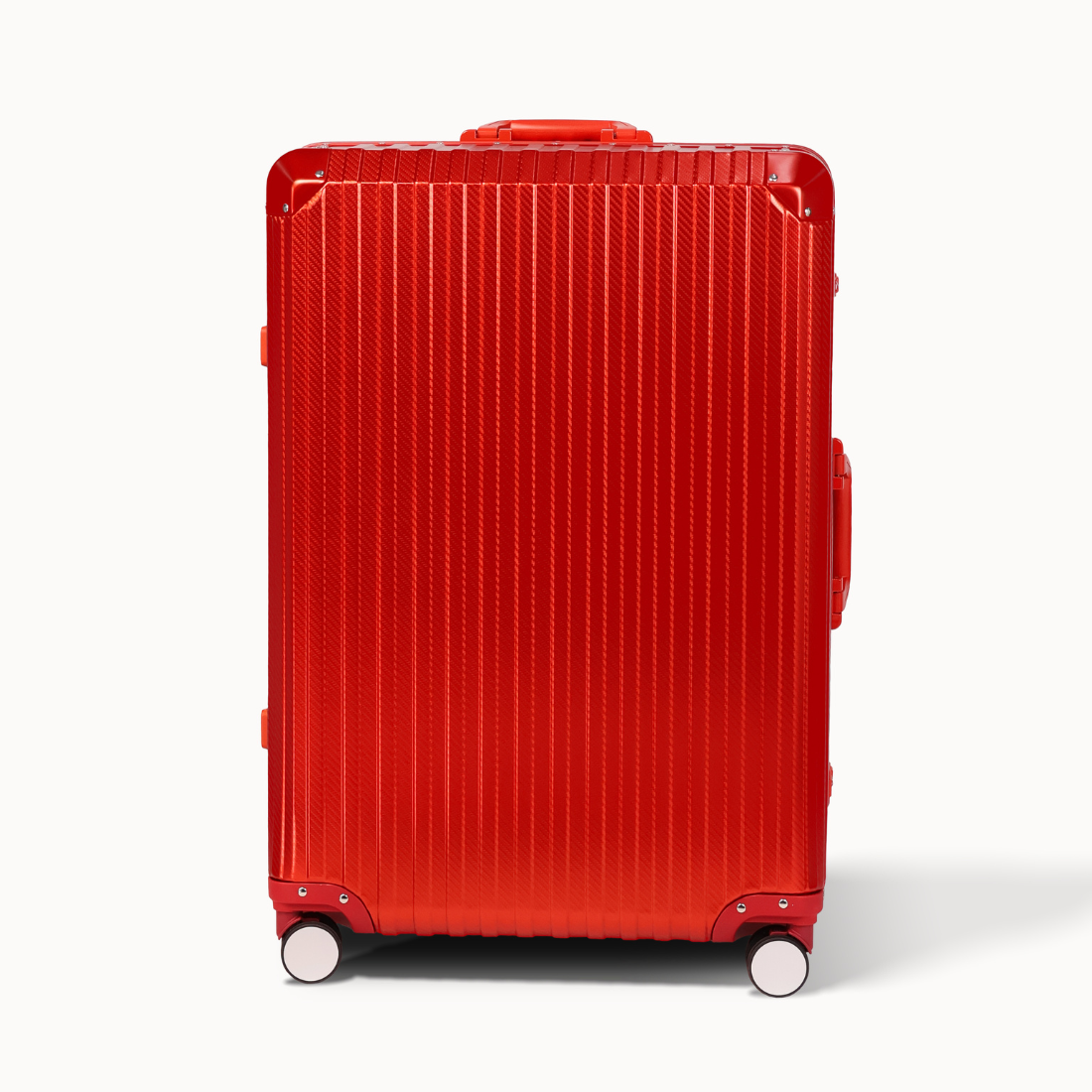 Red suitcase with a ribbed texture on a white background