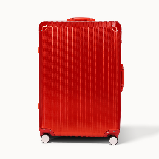 Red suitcase with a ribbed texture on a white background