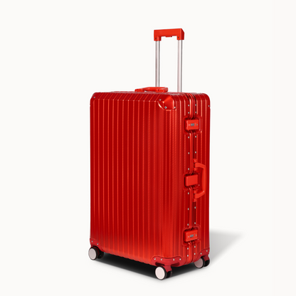 Red suitcase with a ribbed texture on a white background