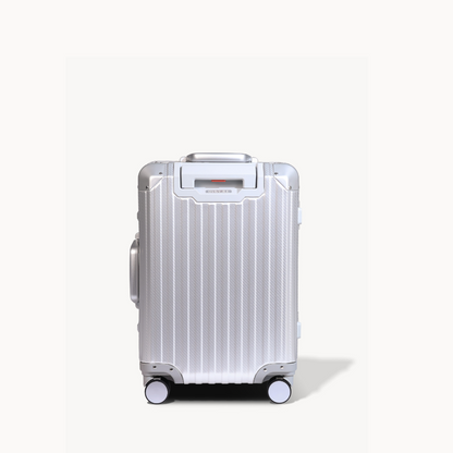 Silver suitcase with wheels on a white background