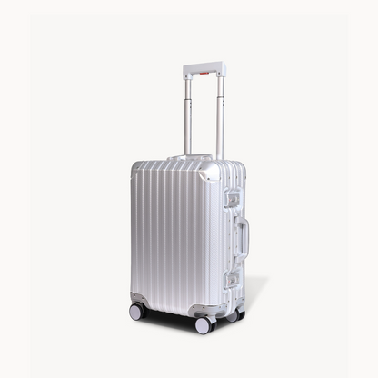 Silver suitcase with a reflective surface on a white background