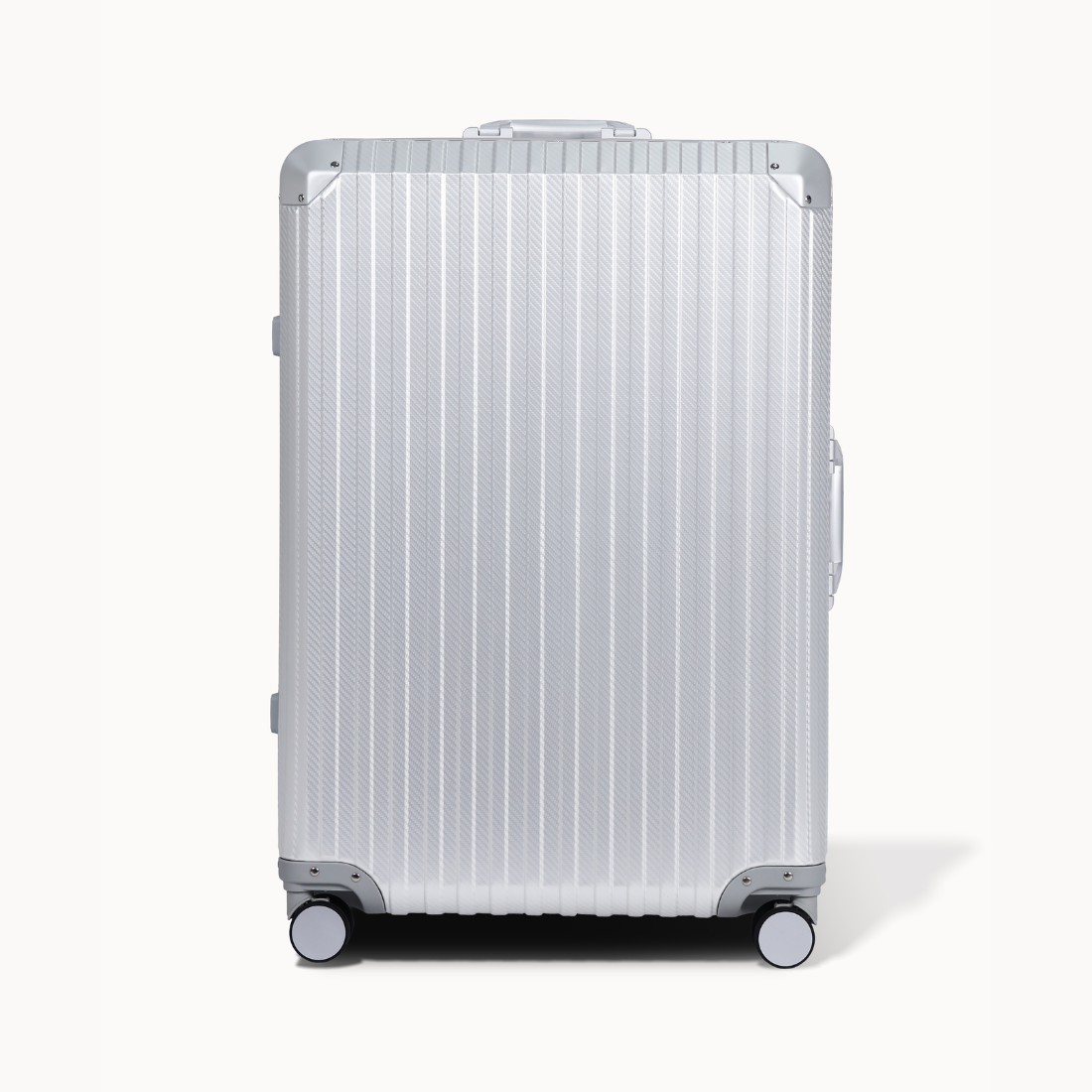 Silver suitcase with a ribbed texture on a white background