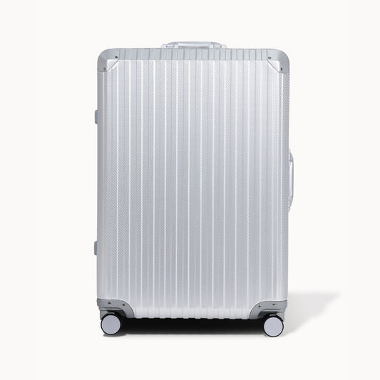 Silver suitcase with a ribbed texture on a white background
