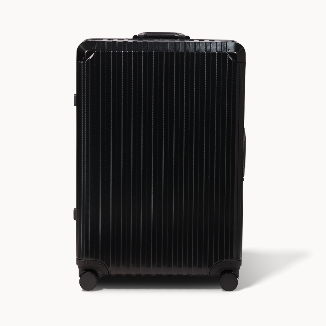 Black suitcase with a ribbed texture on a white background