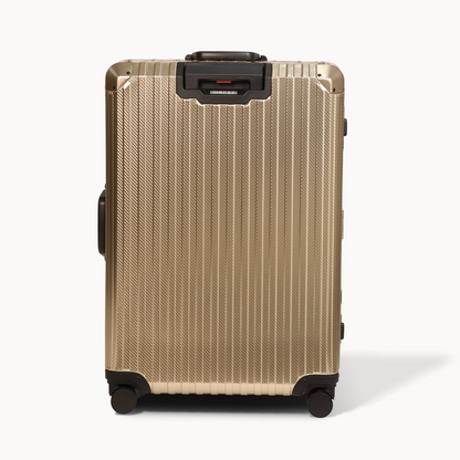 Gold suitcase with black wheels and handle on a white background