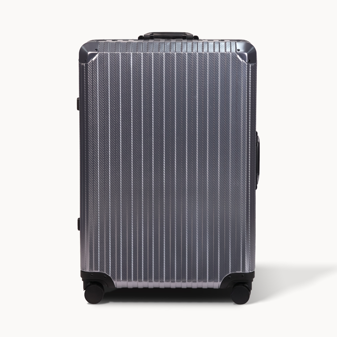 Silver suitcase with black wheels on a white background