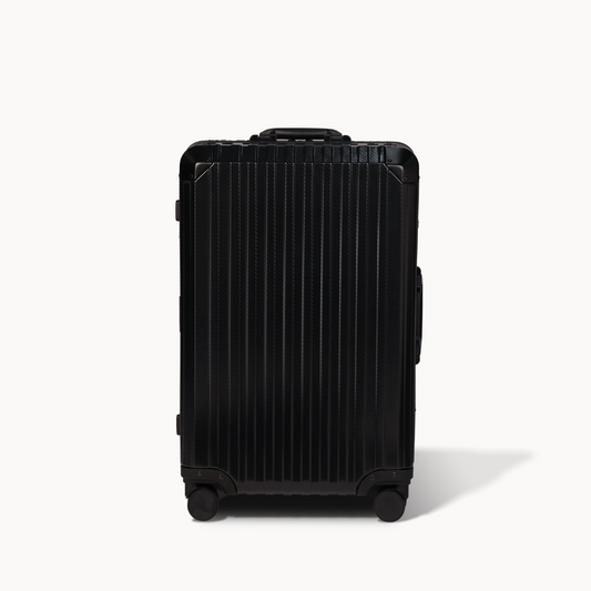 Black suitcase with a ribbed texture on a white background