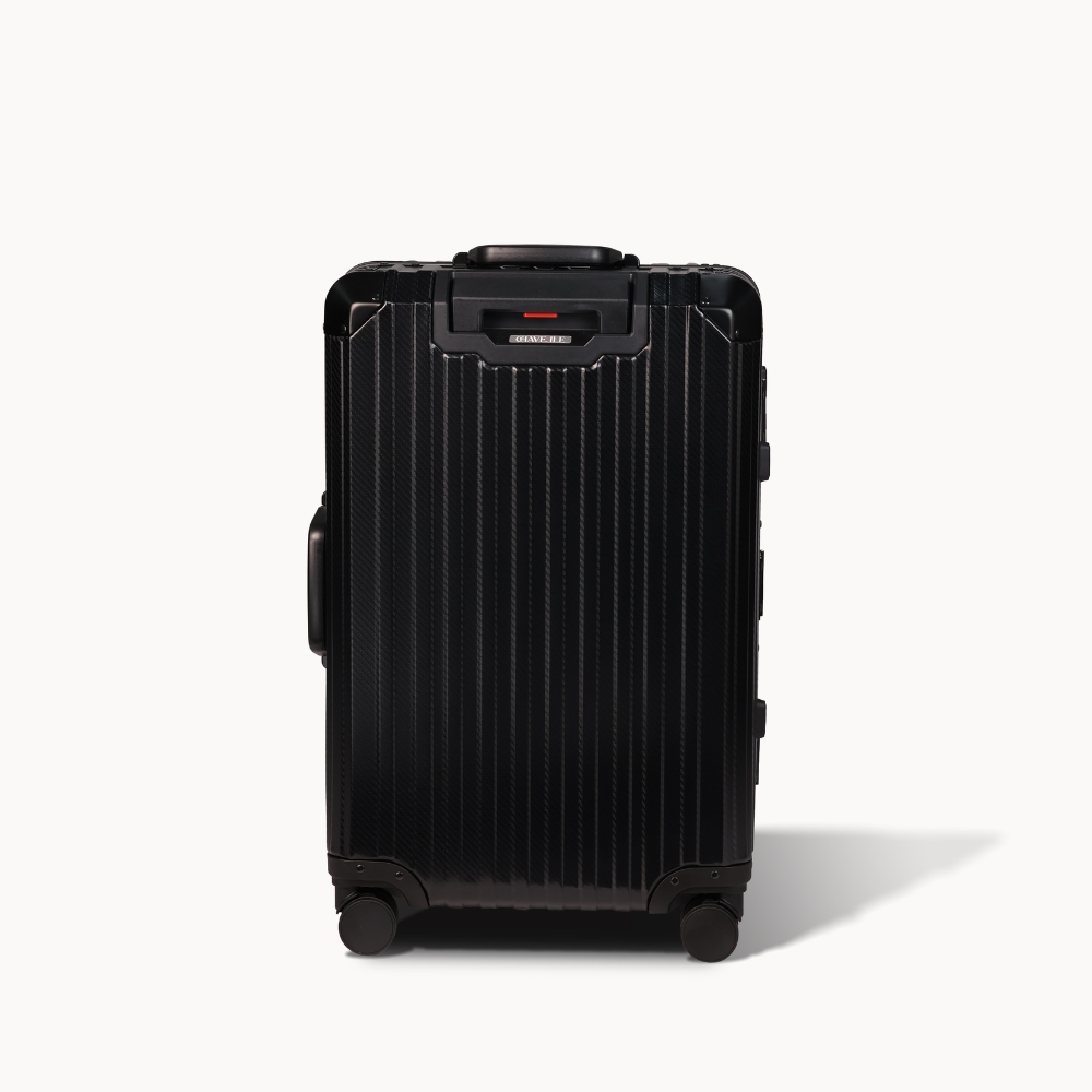 Black suitcase with a textured surface on a white background