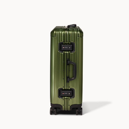 Green suitcase with black handle and wheels on a white background