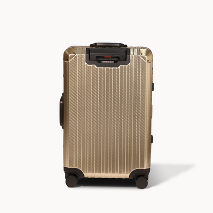 Gold suitcase with black wheels and handle on a white background