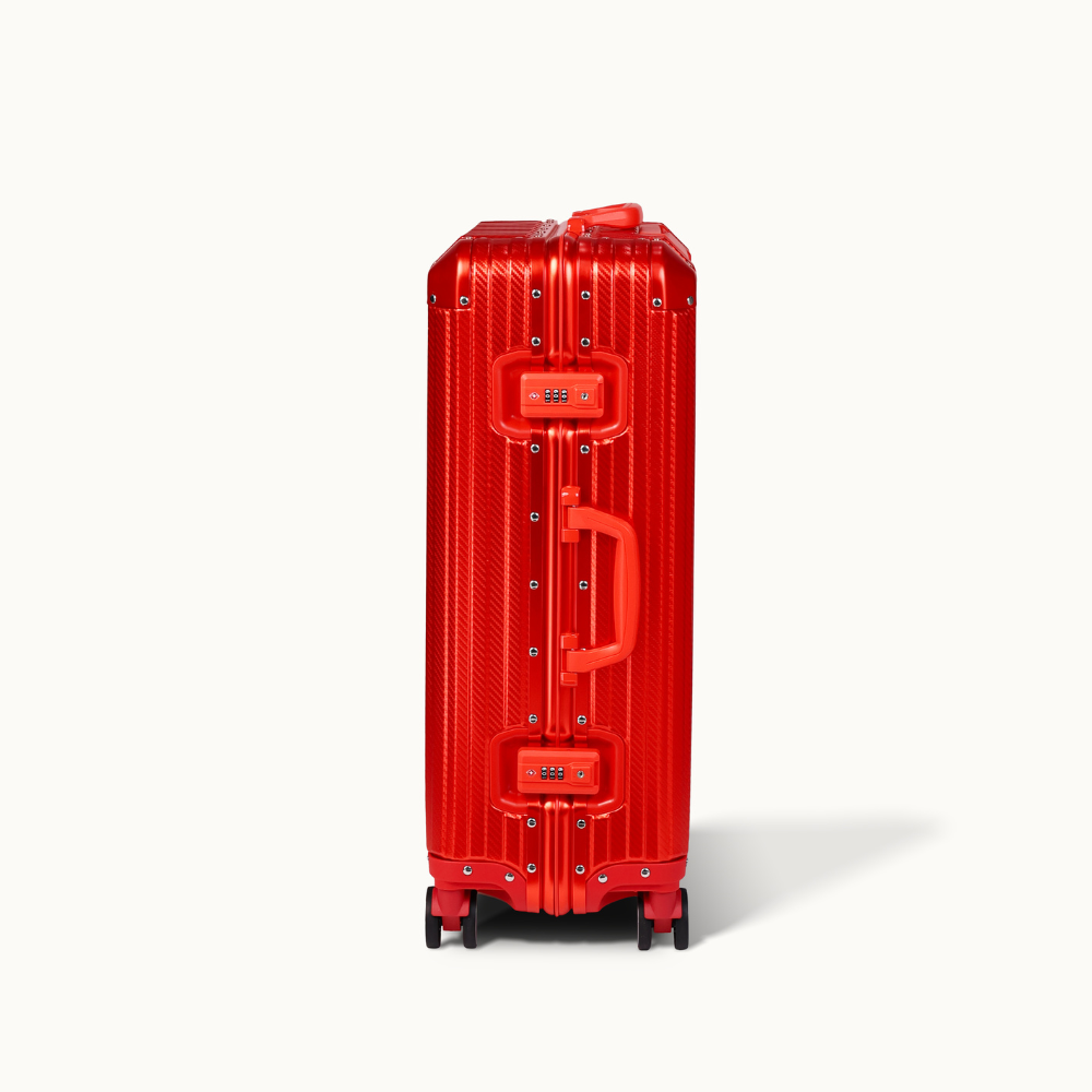 Red suitcase with a textured surface on a white background