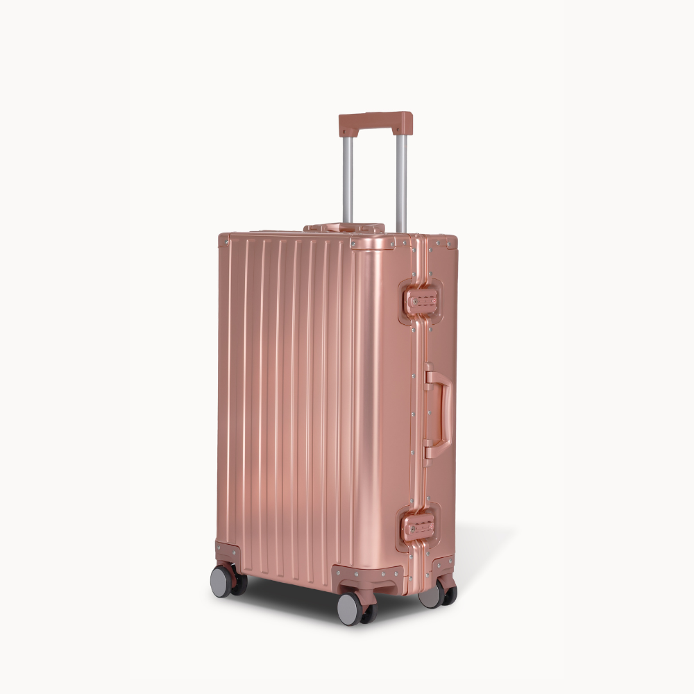 CHAVELLE aluminium suitcase rose gold angled view showing reinforced corners and sleek finish 