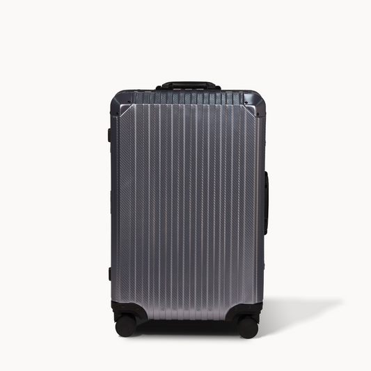 Silver suitcase with black accents on a white background