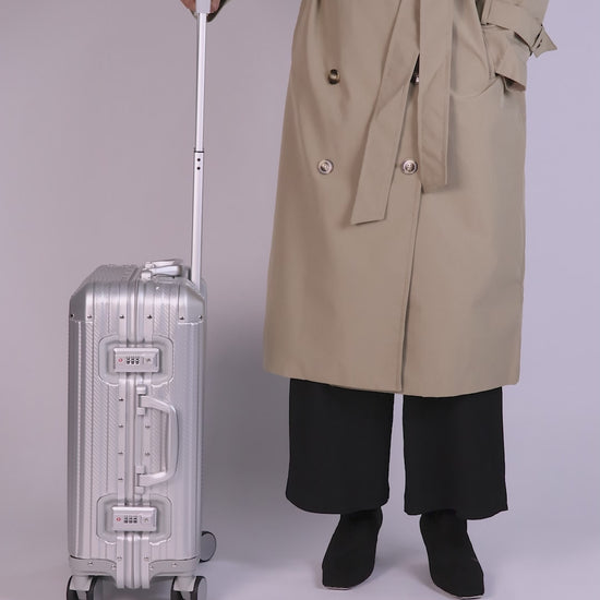 Women Holding Chavelle silver luggage