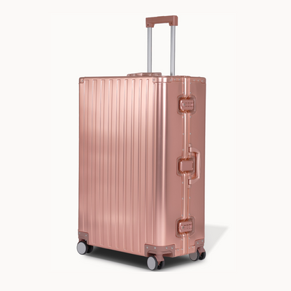CHAVELLE aluminium suitcase rose gold angled view showing reinforced corners and sleek finish 