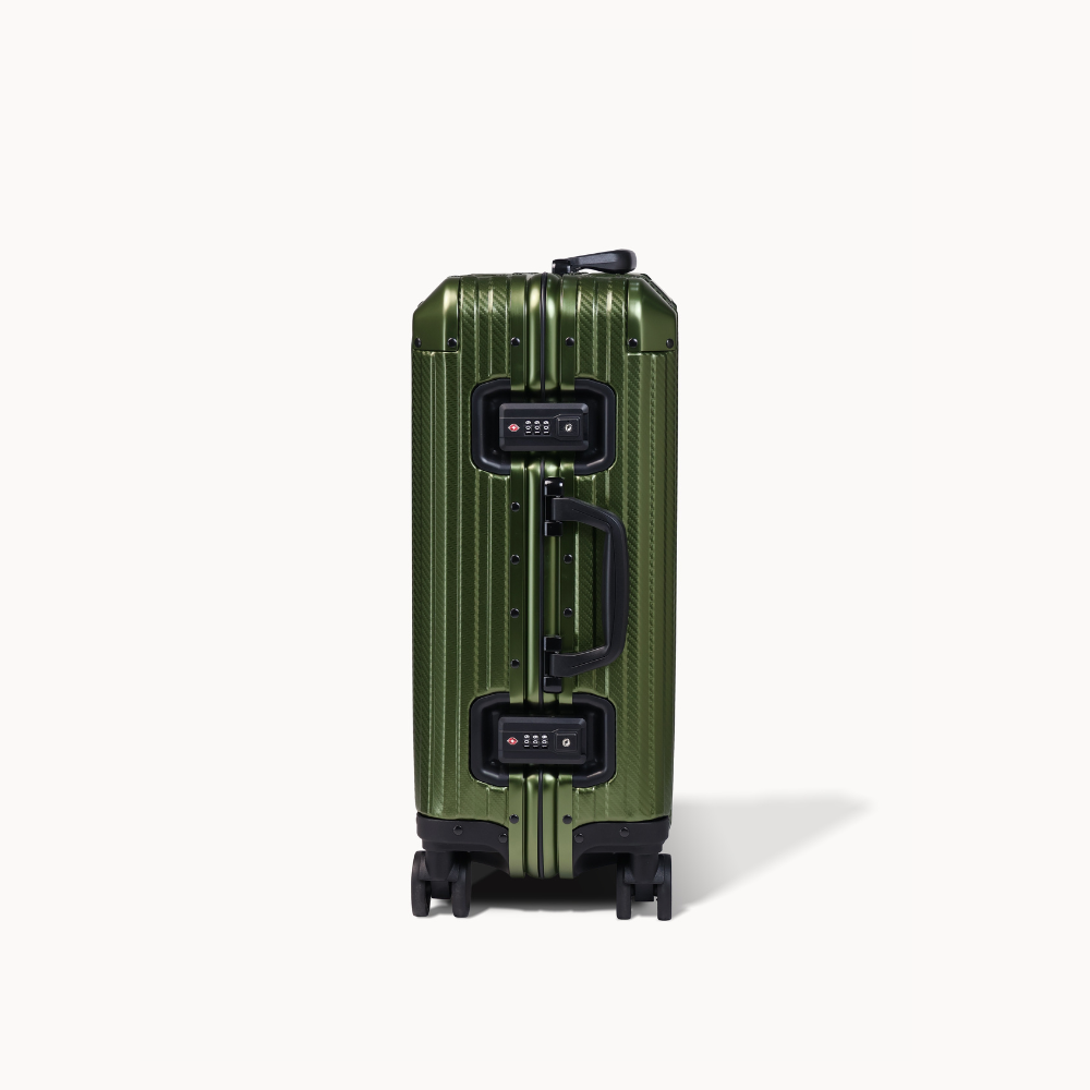 Green suitcase with black handle and wheels on a white background