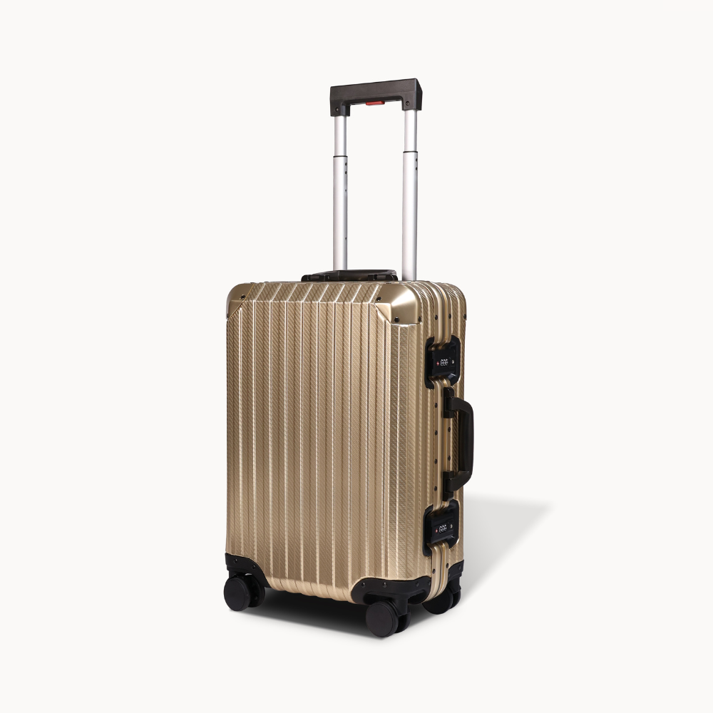 Gold suitcase with black wheels and handle on a white background