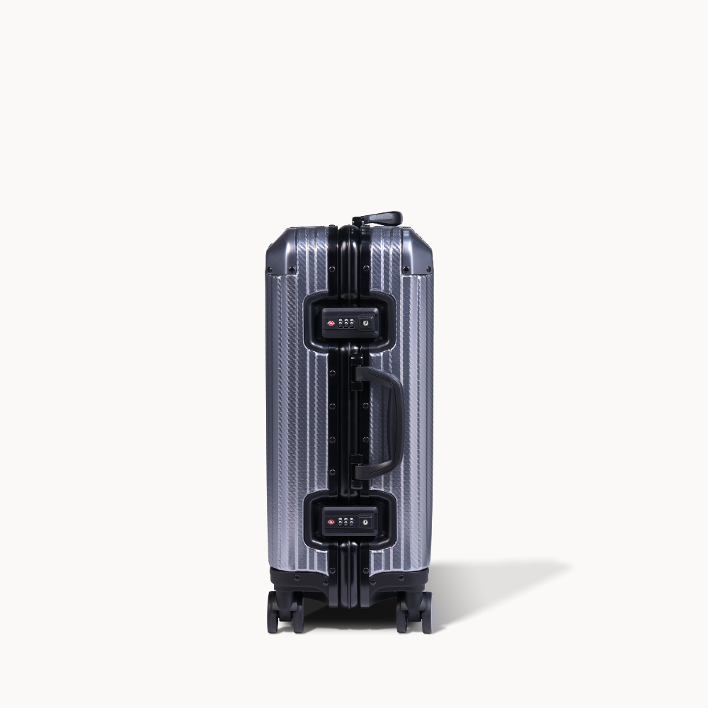 Silver suitcase with black accents on a white background