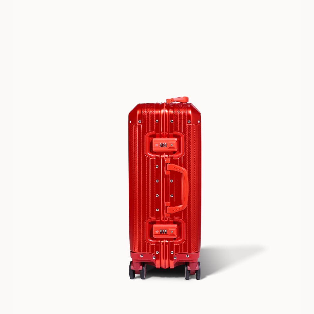 Red suitcase with a clear cover on a white background