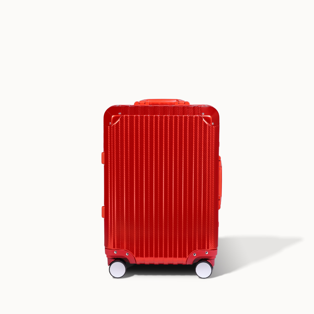Red suitcase with a textured surface on a white background